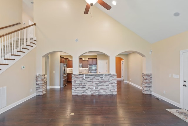 5010 Moretto Ct, Spring Hill, TN 37174 - unfurnished living room featuring ceiling fan, dark wood-style floors, high vaulted ceiling, and stairway