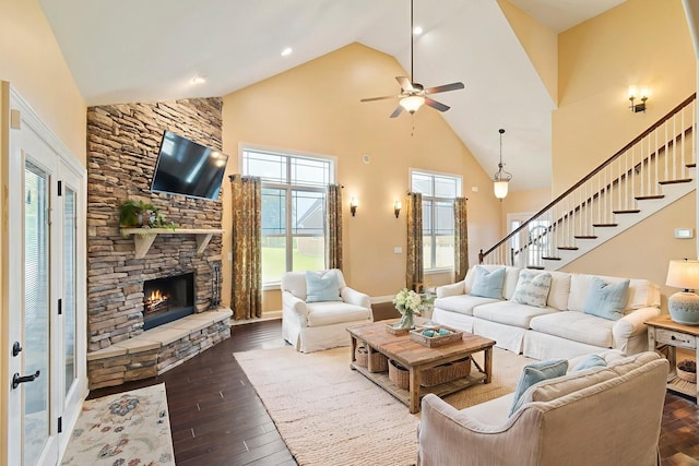 5010 Moretto Ct, Spring Hill, TN 37174 - living area with high vaulted ceiling, a ceiling fan, dark wood-type flooring, a stone fireplace, and stairs