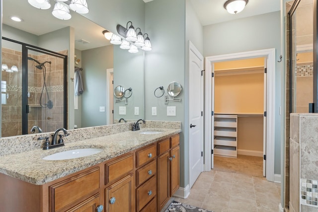 5010 Moretto Ct, Spring Hill, TN 37174 - bathroom featuring a stall shower, double vanity, a spacious closet, and tile patterned floors