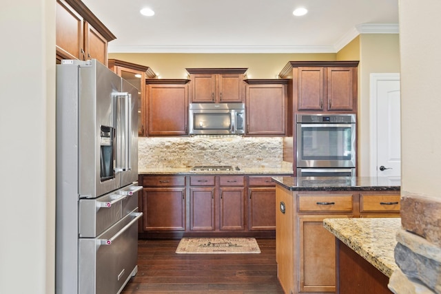 5010 Moretto Ct, Spring Hill, TN 37174 - kitchen featuring stainless steel appliances, tasteful backsplash, ornamental molding, stone counters, and dark wood-type flooring