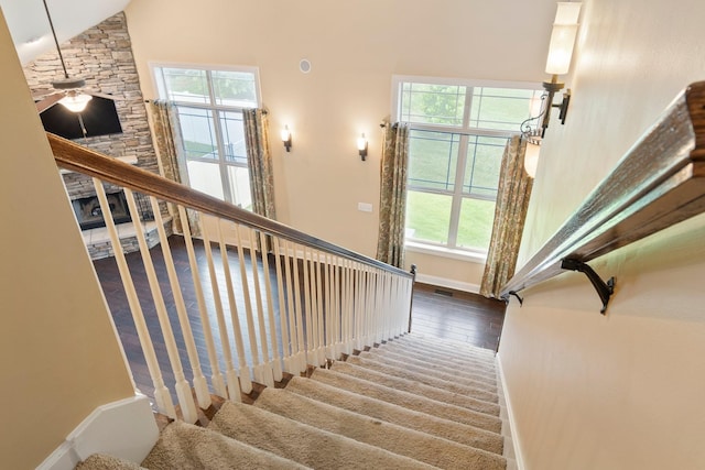 5010 Moretto Ct, Spring Hill, TN 37174 - stairway featuring plenty of natural light, wood finished floors, ceiling fan, and high vaulted ceiling