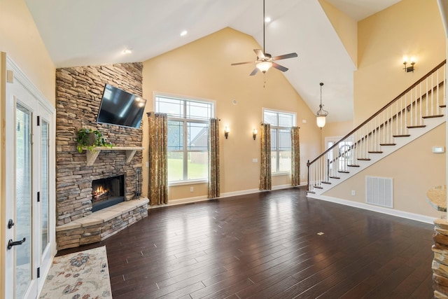 5010 Moretto Ct, Spring Hill, TN 37174 - unfurnished living room featuring high vaulted ceiling, stairway, a stone fireplace, a ceiling fan, and wood-type flooring