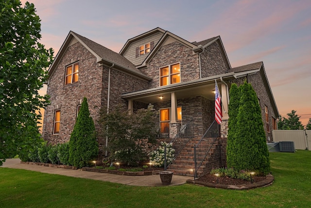 5010 Moretto Ct, Spring Hill, TN 37174 - craftsman-style house with covered porch, a front lawn, stairs, and brick siding