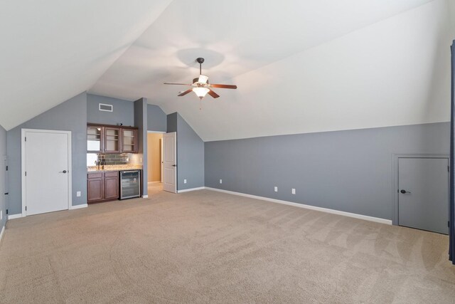 5010 Moretto Ct, Spring Hill, TN 37174 - additional living space with beverage cooler, a ceiling fan, light colored carpet, and vaulted ceiling