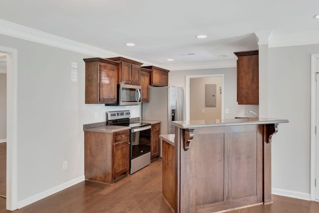 1205 Slaters Creek Rd, Goodlettsville, TN 37072 - kitchen featuring appliances with stainless steel finishes, wood finished floors, ornamental molding, a breakfast bar area, and light stone countertops