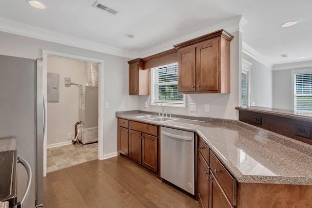 1205 Slaters Creek Rd, Goodlettsville, TN 37072 - kitchen featuring appliances with stainless steel finishes, healthy amount of natural light, dark wood-type flooring, brown cabinetry, and ornamental molding