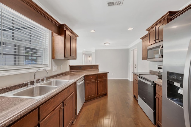 1205 Slaters Creek Rd, Goodlettsville, TN 37072 - kitchen featuring appliances with stainless steel finishes, crown molding, dark wood-style floors, a peninsula, and recessed lighting