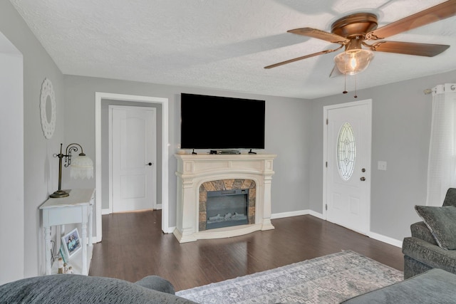2750 Clampit Hollow Rd, Lafayette, TN 37083 - living area with a ceiling fan, dark wood finished floors, a fireplace, and a textured ceiling