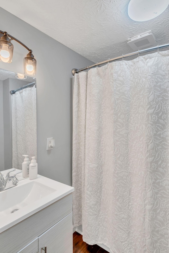 2750 Clampit Hollow Rd, Lafayette, TN 37083 - bathroom with vanity, wood finished floors, and a textured ceiling