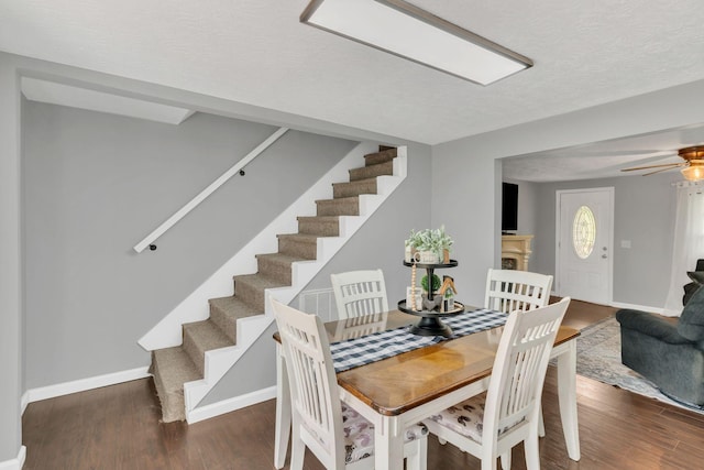 2750 Clampit Hollow Rd, Lafayette, TN 37083 - dining space featuring stairs, wood finished floors, a ceiling fan, and a textured ceiling