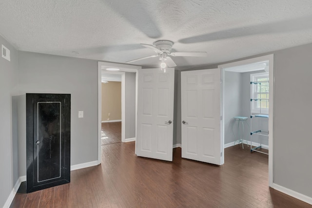 2750 Clampit Hollow Rd, Lafayette, TN 37083 - unfurnished bedroom featuring dark wood finished floors, a textured ceiling, and ceiling fan