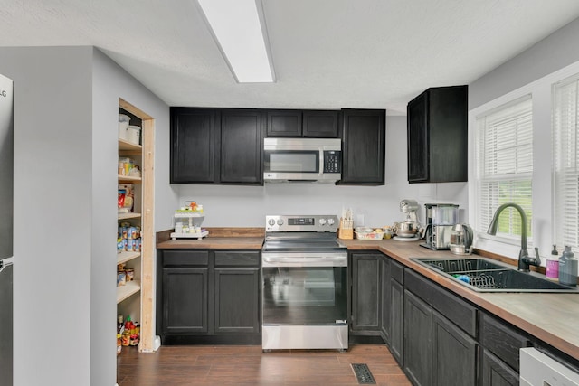 2750 Clampit Hollow Rd, Lafayette, TN 37083 - kitchen with appliances with stainless steel finishes and dark wood-type flooring