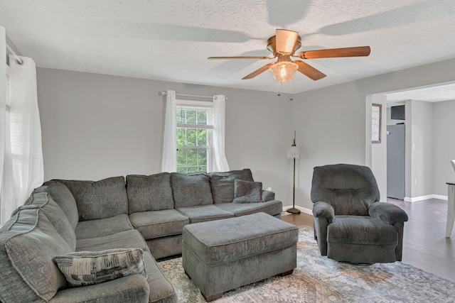 2750 Clampit Hollow Rd, Lafayette, TN 37083 - living area featuring wood finished floors, ceiling fan, and a textured ceiling