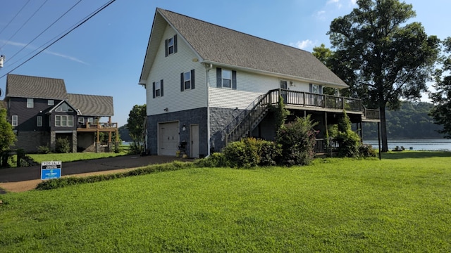1178 Miracle Rd, Decaturville, TN 38329 - rear view of property featuring a yard, stairs, driveway, a garage, and a shingled roof