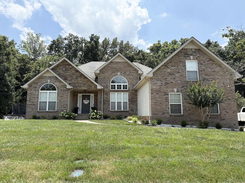 4392 Taylor Hall Ln, Adams, TN 37010 - view of front of house with brick siding and a front yard