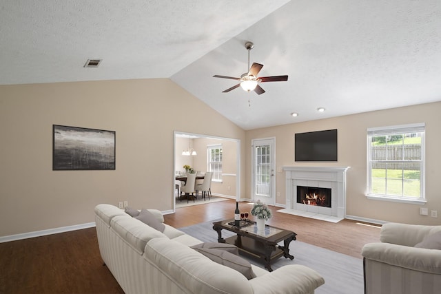 1918 Lawndale Dr, Spring Hill, TN 37174 - living room featuring wood finished floors, lofted ceiling, a textured ceiling, ceiling fan, and a tile fireplace