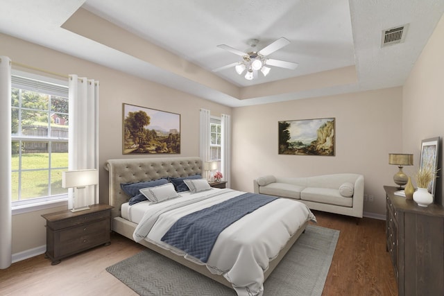 1918 Lawndale Dr, Spring Hill, TN 37174 - bedroom featuring a raised ceiling, multiple windows, wood finished floors, and a ceiling fan