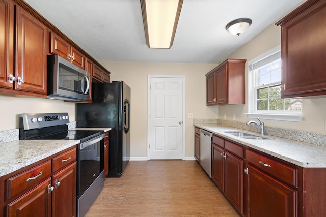 1918 Lawndale Dr, Spring Hill, TN 37174 - kitchen featuring appliances with stainless steel finishes, light wood-style flooring, and light stone countertops