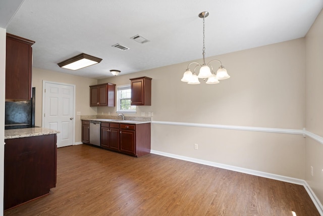 1918 Lawndale Dr, Spring Hill, TN 37174 - kitchen featuring stainless steel dishwasher, wood finished floors, a chandelier, hanging light fixtures, and fridge