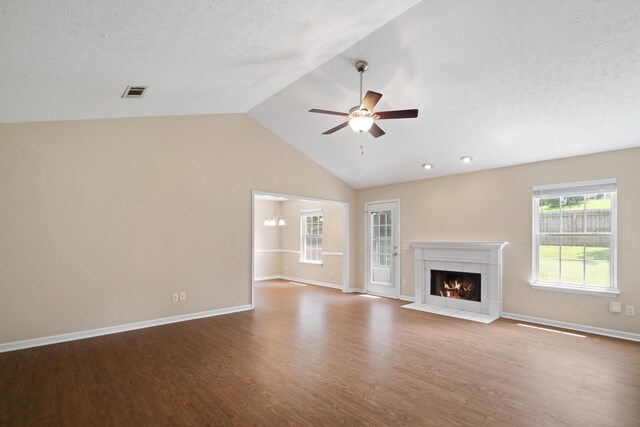 1918 Lawndale Dr, Spring Hill, TN 37174 - unfurnished living room with wood finished floors, a tiled fireplace, a textured ceiling, ceiling fan, and high vaulted ceiling