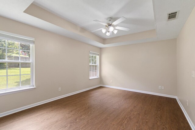 1918 Lawndale Dr, Spring Hill, TN 37174 - spare room featuring a raised ceiling, dark wood finished floors, and healthy amount of natural light