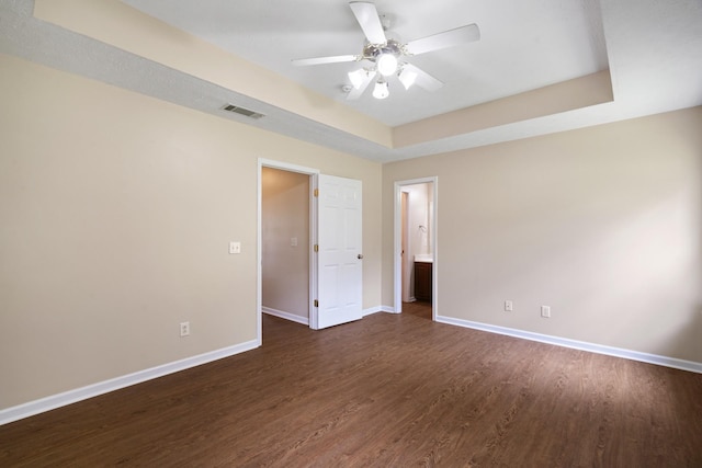 1918 Lawndale Dr, Spring Hill, TN 37174 - unfurnished bedroom featuring a tray ceiling, dark wood-style floors, and ceiling fan