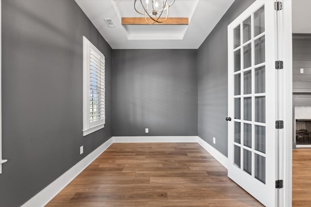 2620 Buckner Ln, Thompsons Station, TN 37179 - spare room with a chandelier, wood finished floors, and a tray ceiling