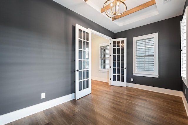 2620 Buckner Ln, Thompsons Station, TN 37179 - unfurnished room with french doors, a raised ceiling, a chandelier, and dark wood-type flooring