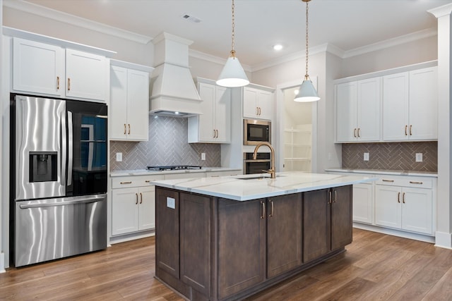 2620 Buckner Ln, Thompsons Station, TN 37179 - kitchen featuring stainless steel appliances, tasteful backsplash, ornamental molding, white cabinets, and wood finished floors