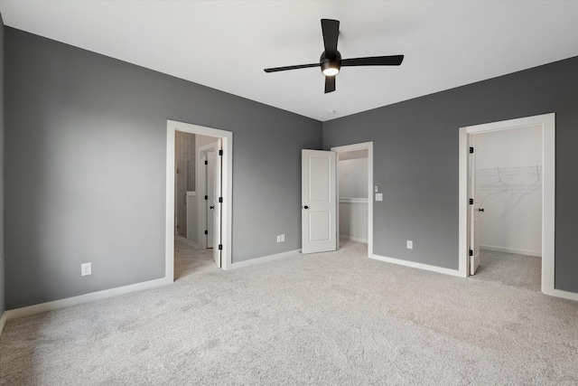 2620 Buckner Ln, Thompsons Station, TN 37179 - unfurnished bedroom with a walk in closet, carpet flooring, a closet, ensuite bath, and ceiling fan