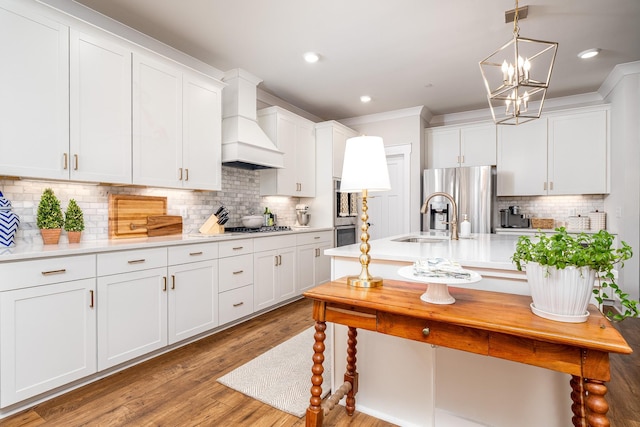 2744 Morrow Ln, Columbia, TN 38401 - kitchen featuring premium range hood, appliances with stainless steel finishes, light countertops, tasteful backsplash, and white cabinetry