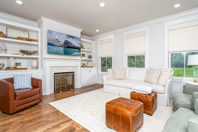 2744 Morrow Ln, Columbia, TN 38401 - living room with wood finished floors, healthy amount of natural light, a tiled fireplace, crown molding, and recessed lighting