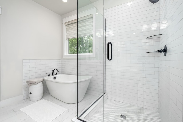 2744 Morrow Ln, Columbia, TN 38401 - full bath featuring a stall shower, a freestanding tub, tile walls, and marble finish floors