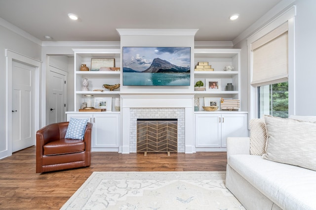 2744 Morrow Ln, Columbia, TN 38401 - living area featuring crown molding, wood finished floors, built in features, and a tiled fireplace