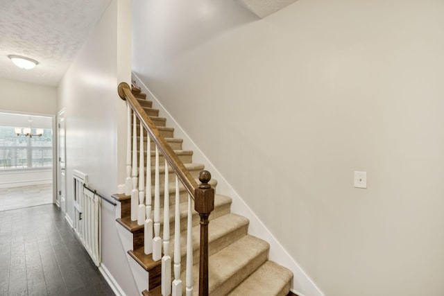2306 New Holland Cir, Murfreesboro, TN 37128 - staircase featuring a chandelier, wood finished floors, and a textured ceiling
