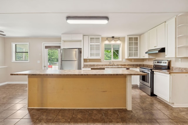 3337 Hartsville Rd, Lafayette, TN 37083 - kitchen with appliances with stainless steel finishes, under cabinet range hood, open shelves, a kitchen island, and plenty of natural light