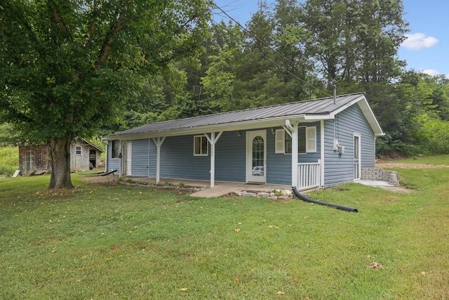 3337 Hartsville Rd, Lafayette, TN 37083 - view of front of property featuring covered porch, a front lawn, a metal roof, and a standing seam roof