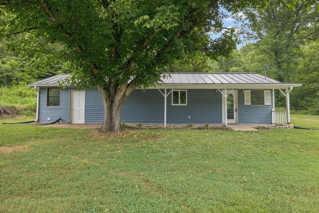 3337 Hartsville Rd, Lafayette, TN 37083 - view of front of property with a front lawn, a standing seam roof, a metal roof, and covered porch