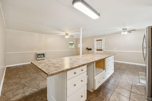 3337 Hartsville Rd, Lafayette, TN 37083 - kitchen featuring ceiling fan, freestanding refrigerator, white cabinetry, and tile patterned floors