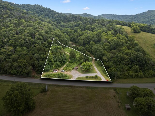 3337 Hartsville Rd, Lafayette, TN 37083 - aerial view of property and surrounding area featuring a forest and property parcel outlined