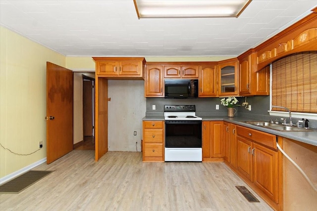 318 David St, Lawrenceburg, TN 38464 - kitchen featuring black microwave, white electric range oven, light wood-style flooring, and glass insert cabinets