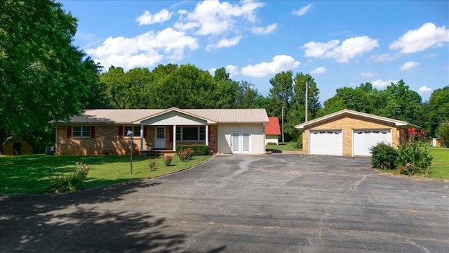 318 David St, Lawrenceburg, TN 38464 - single story home featuring a garage, a porch, a front yard, a metal roof, and an outdoor structure