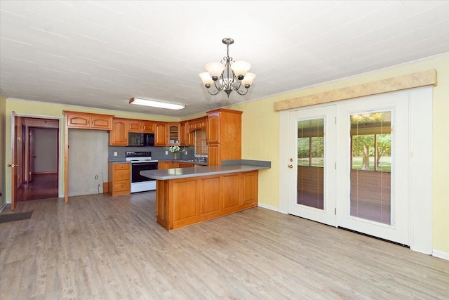 318 David St, Lawrenceburg, TN 38464 - kitchen featuring white range with electric stovetop, black microwave, a chandelier, a peninsula, and light wood-type flooring