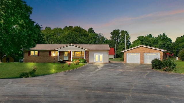 318 David St, Lawrenceburg, TN 38464 - single story home featuring a detached garage, a front yard, an outdoor structure, and a metal roof