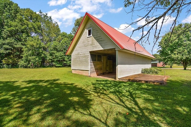 318 David St, Lawrenceburg, TN 38464 - view of side of home featuring a yard, a metal roof, and an outbuilding