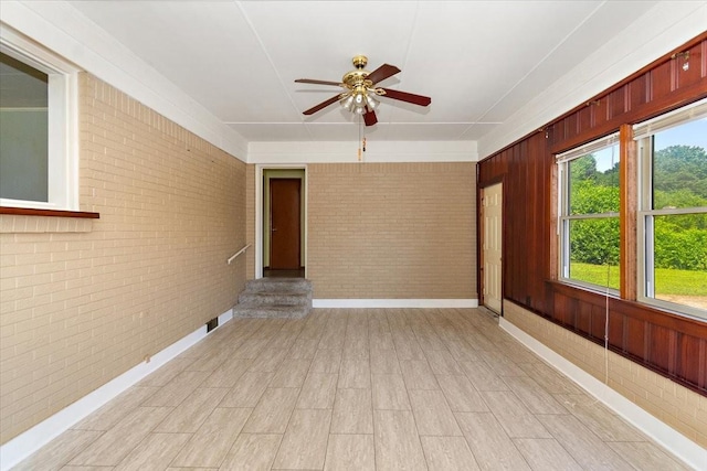318 David St, Lawrenceburg, TN 38464 - unfurnished room with brick wall, a ceiling fan, and light wood-style flooring