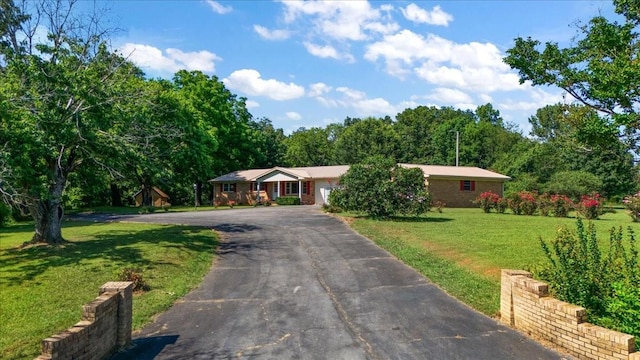 318 David St, Lawrenceburg, TN 38464 - single story home with driveway, a front yard, and a garage