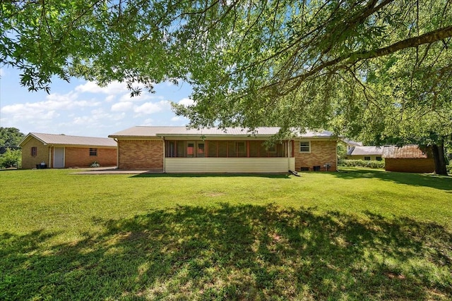 318 David St, Lawrenceburg, TN 38464 - back of property featuring brick siding, a yard, and a metal roof