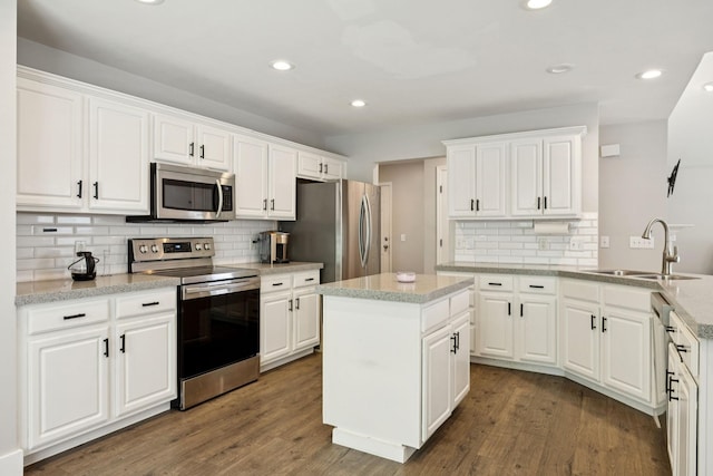 808 Garrett Way Ct, Antioch, TN 37013 - kitchen featuring stainless steel appliances, decorative backsplash, white cabinetry, wood finished floors, and recessed lighting