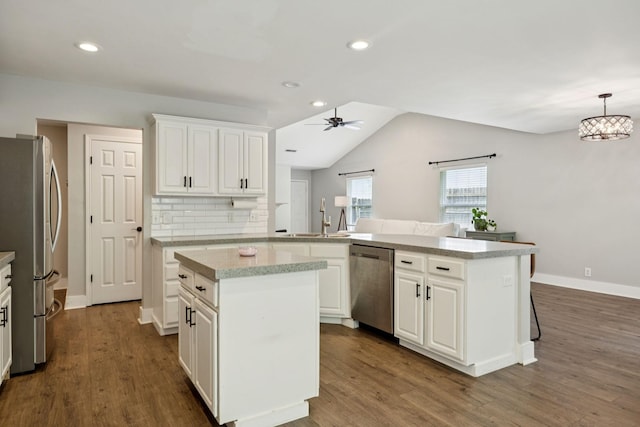 808 Garrett Way Ct, Antioch, TN 37013 - kitchen with stainless steel appliances, ceiling fan, a kitchen island, light countertops, and dark wood finished floors